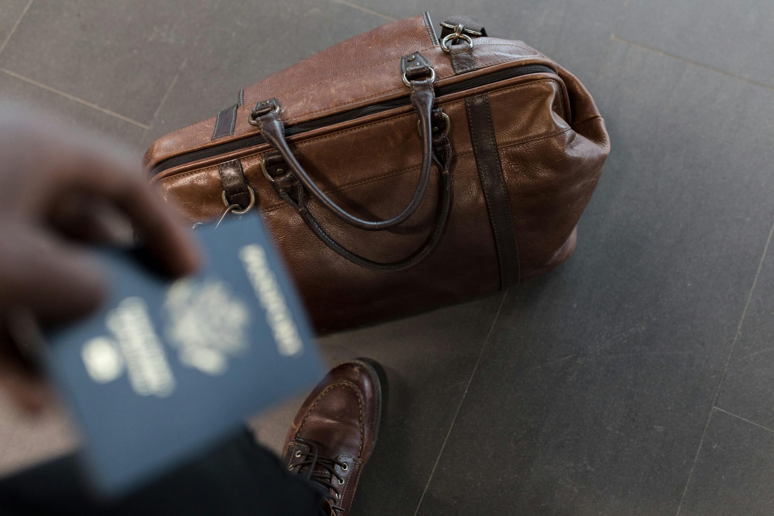 a suitcase bursting open from overpacking at an airport