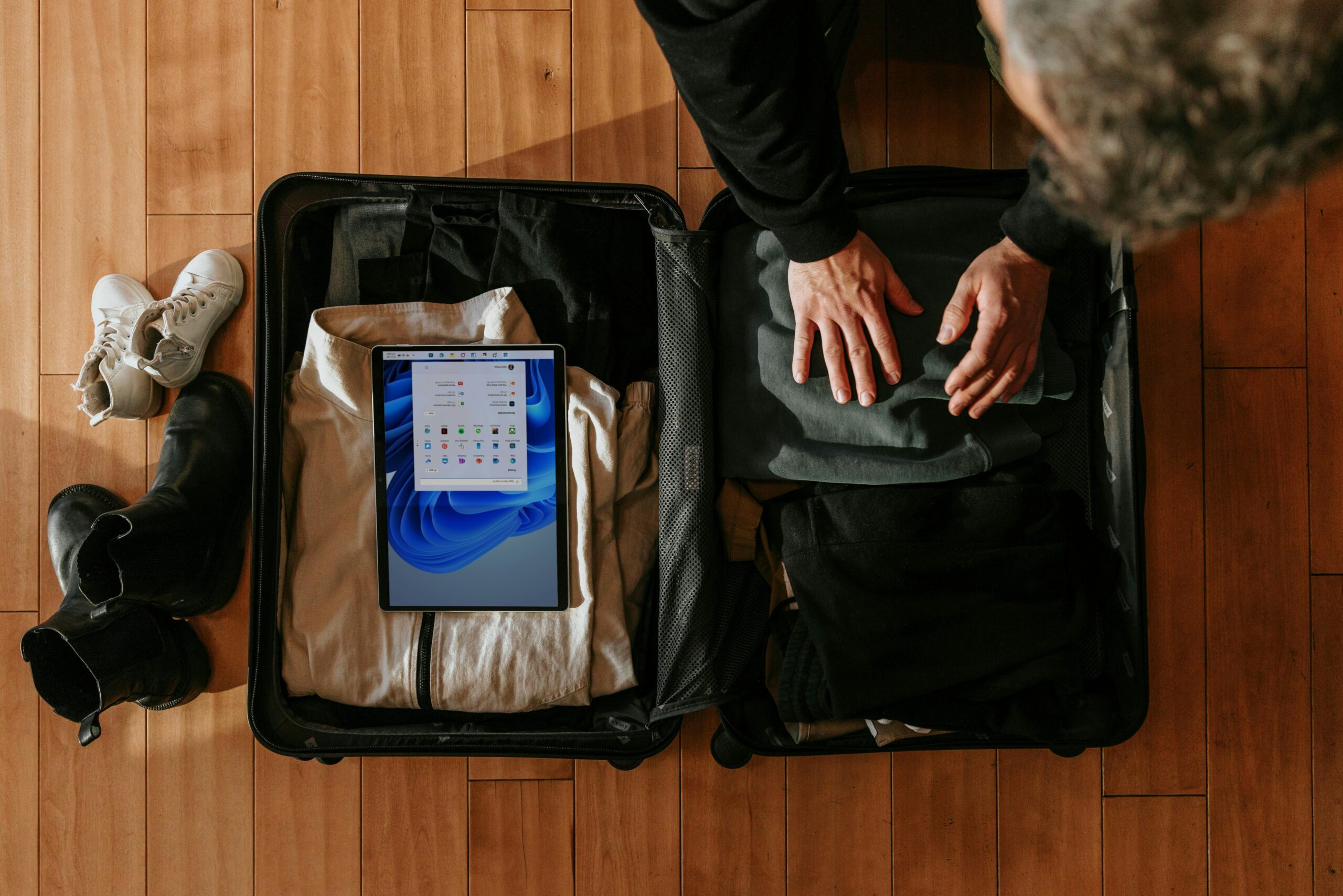 A suitcase bursting open with clothes spilling out