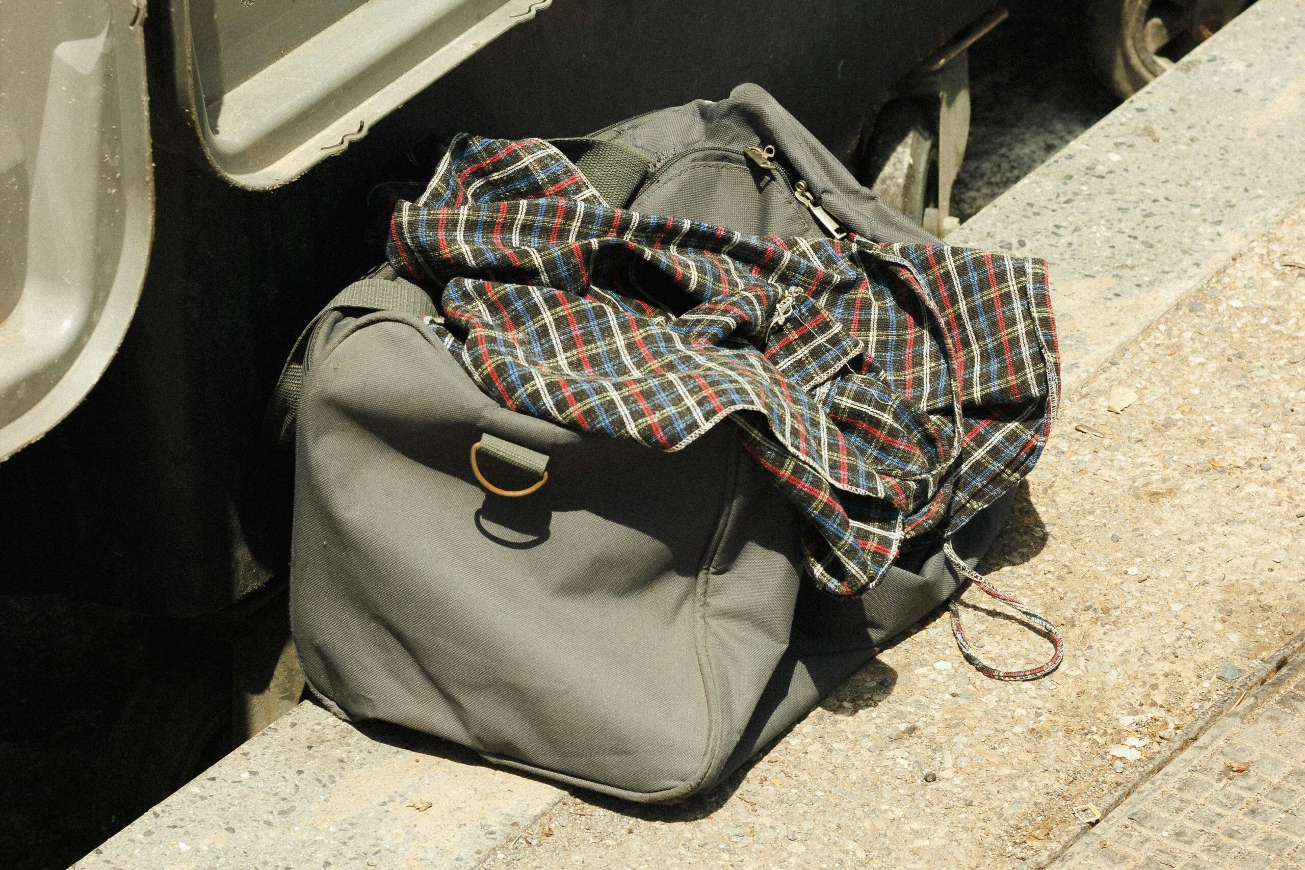 Illustration showing a frustrated traveler struggling to close an overpacked suitcase
