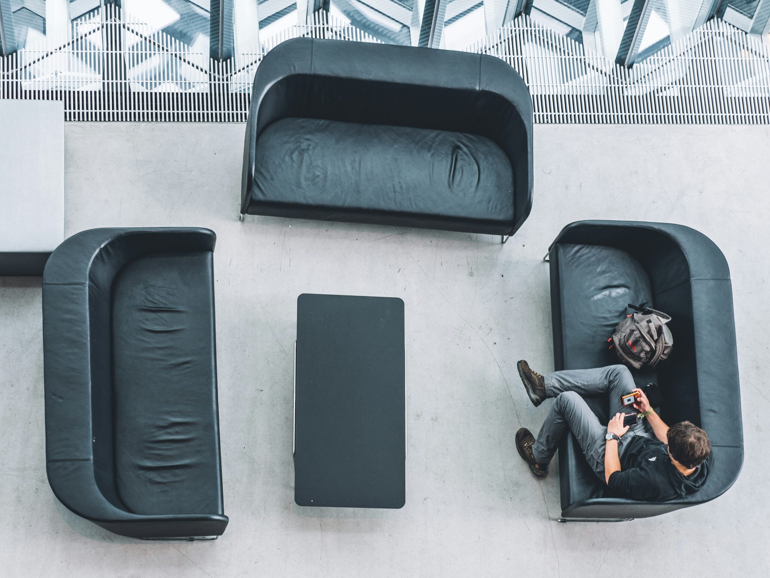 A sleek black expandable suitcase with multiple inner compartments laid open on white background
