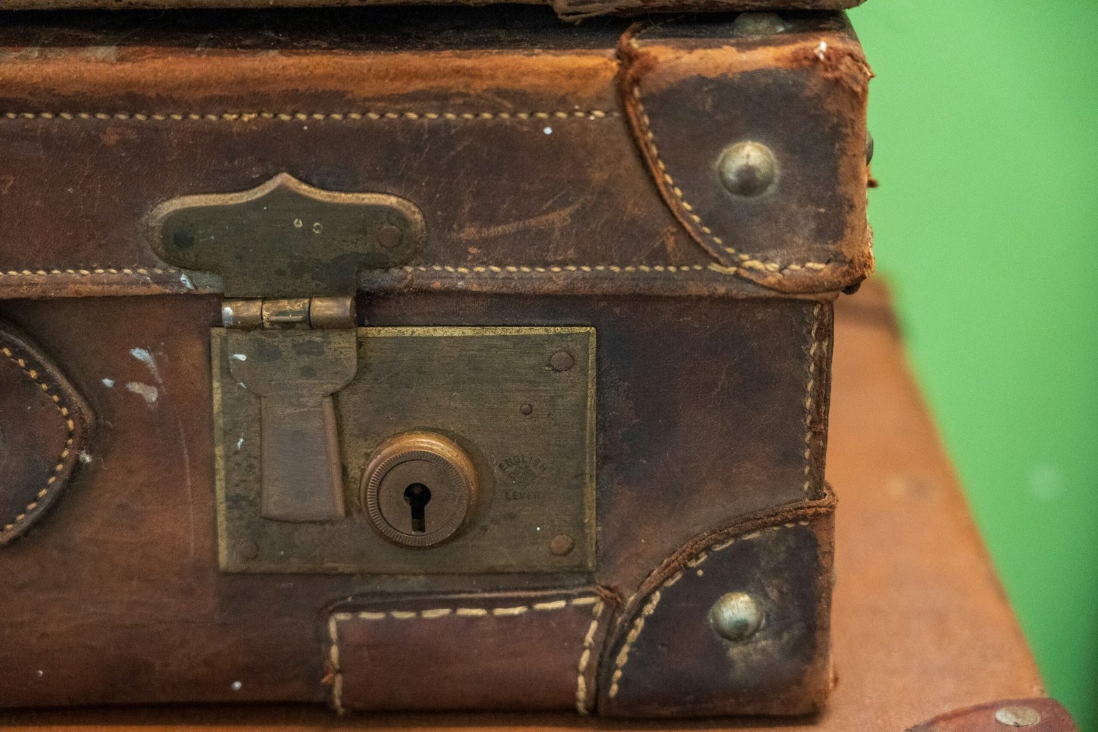 A woman smiling next to her expanded travel flex suitcase filled with souvenirs.