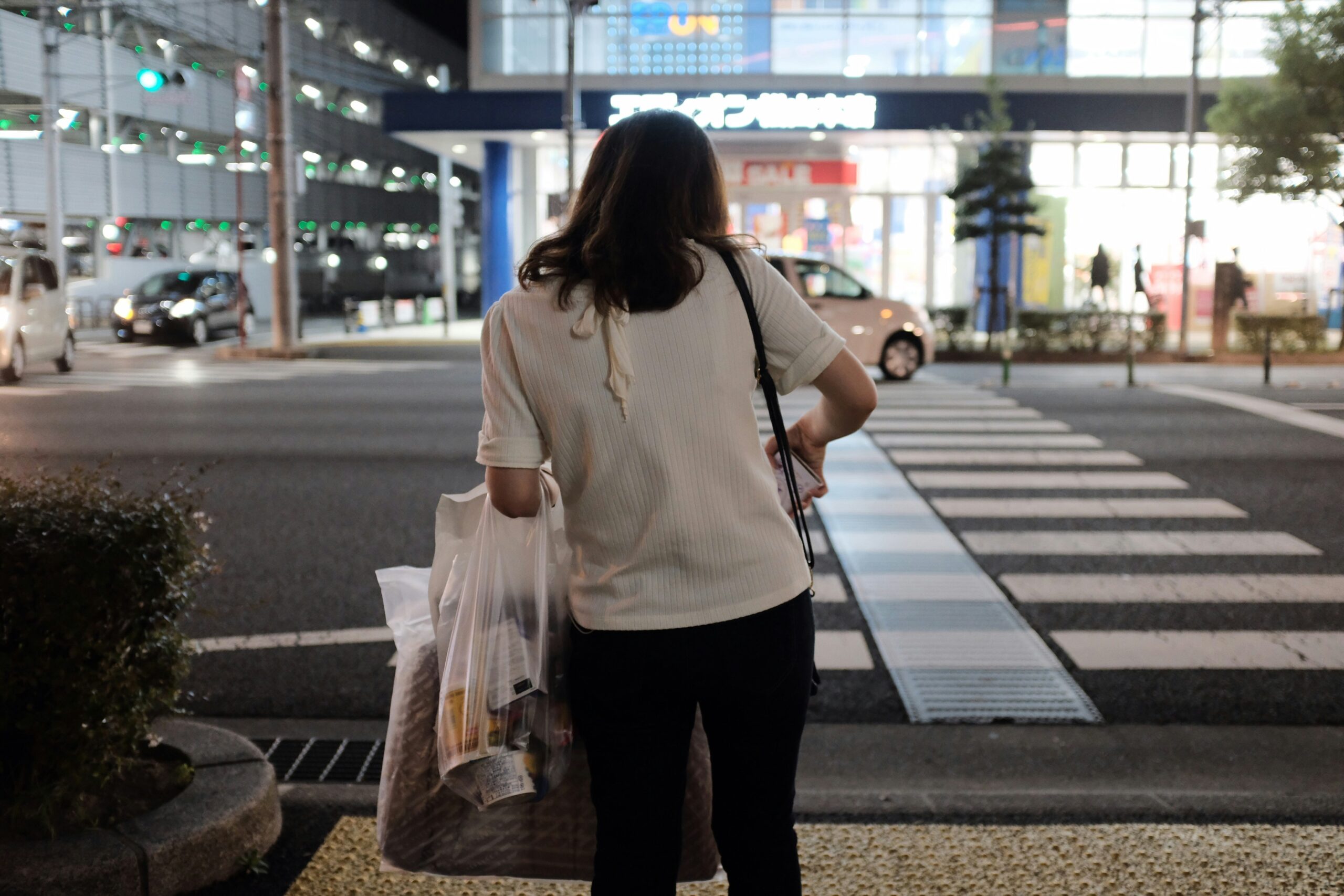 Happy traveler pulling an expandable carry-on behind them at an airport terminal.