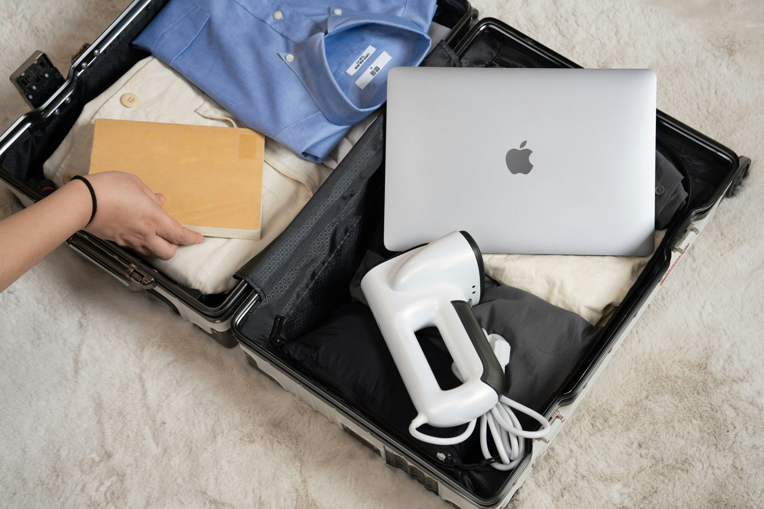 Smiling traveler standing next to neatly packed expandable luggage