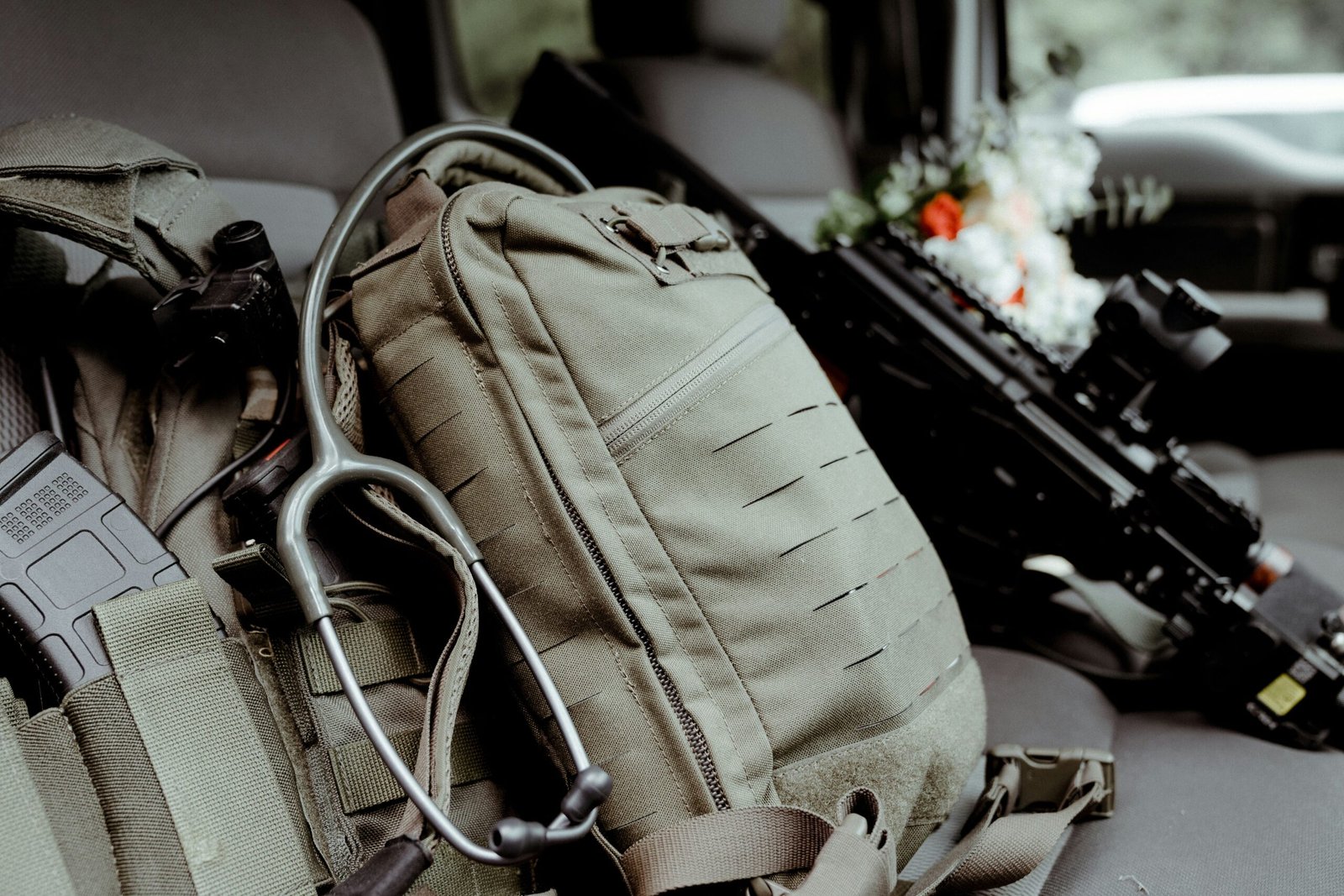 A woman struggling to close an overstuffed suitcase.