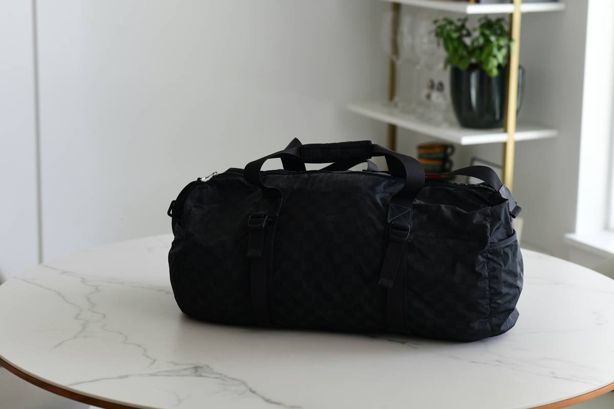 Comparison chart showing weight, expanded capacity, and material specs of top flex pack lightweight duffel brands including Eagle Creek, Patagonia, and Away