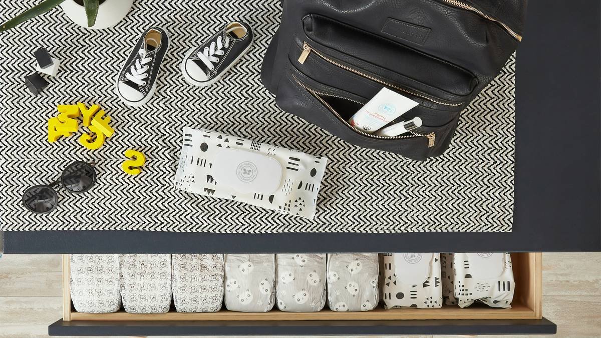 a black and white table with a black bag and shoes