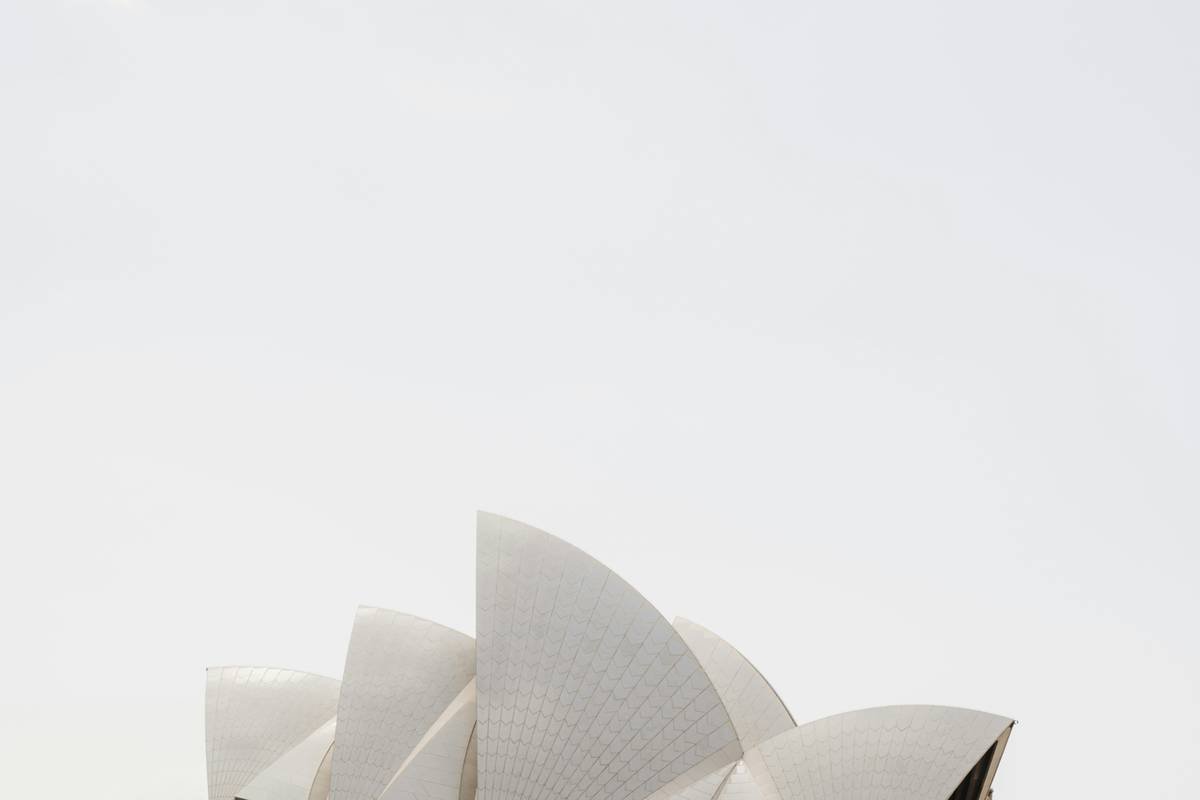 a large white building with sails on top of it