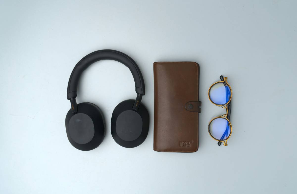 A neatly arranged flat-lay of my everyday carry items on a clean white tabletop. This EDC collection features essentials like a wallet, headphones and spectacles—capturing a minimalist yet practical lifestyle setup. Ideal for those inspired by organization, productivity, and clean design aesthetics.
