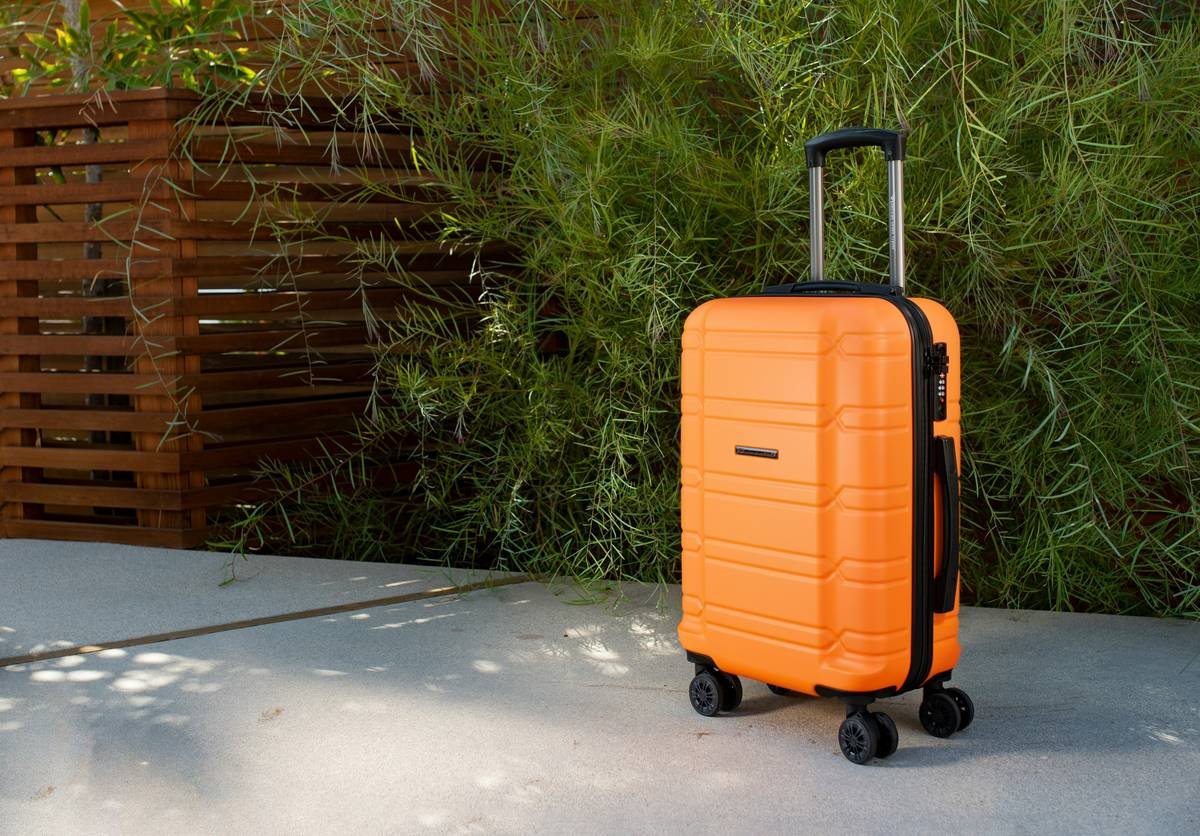 Allegro airline-approved carry-on from American Green Travel (orange).