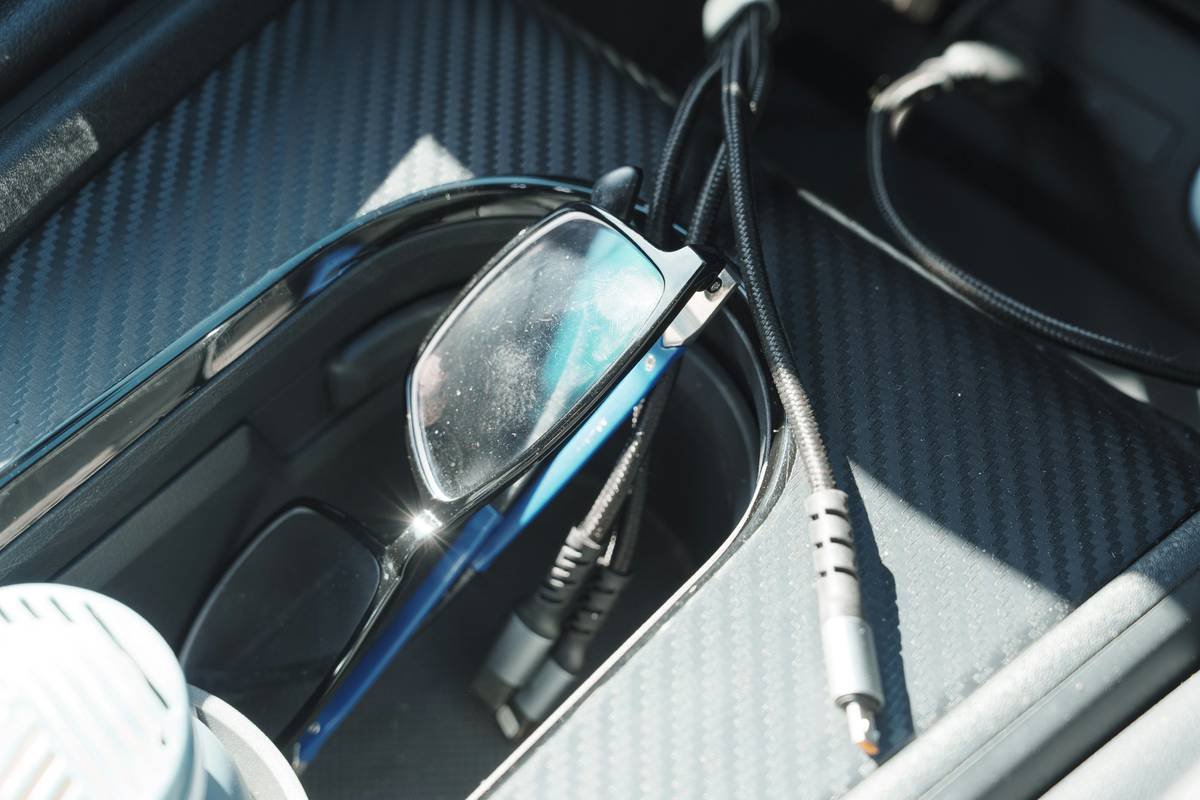 Glasses and cables in a car console.