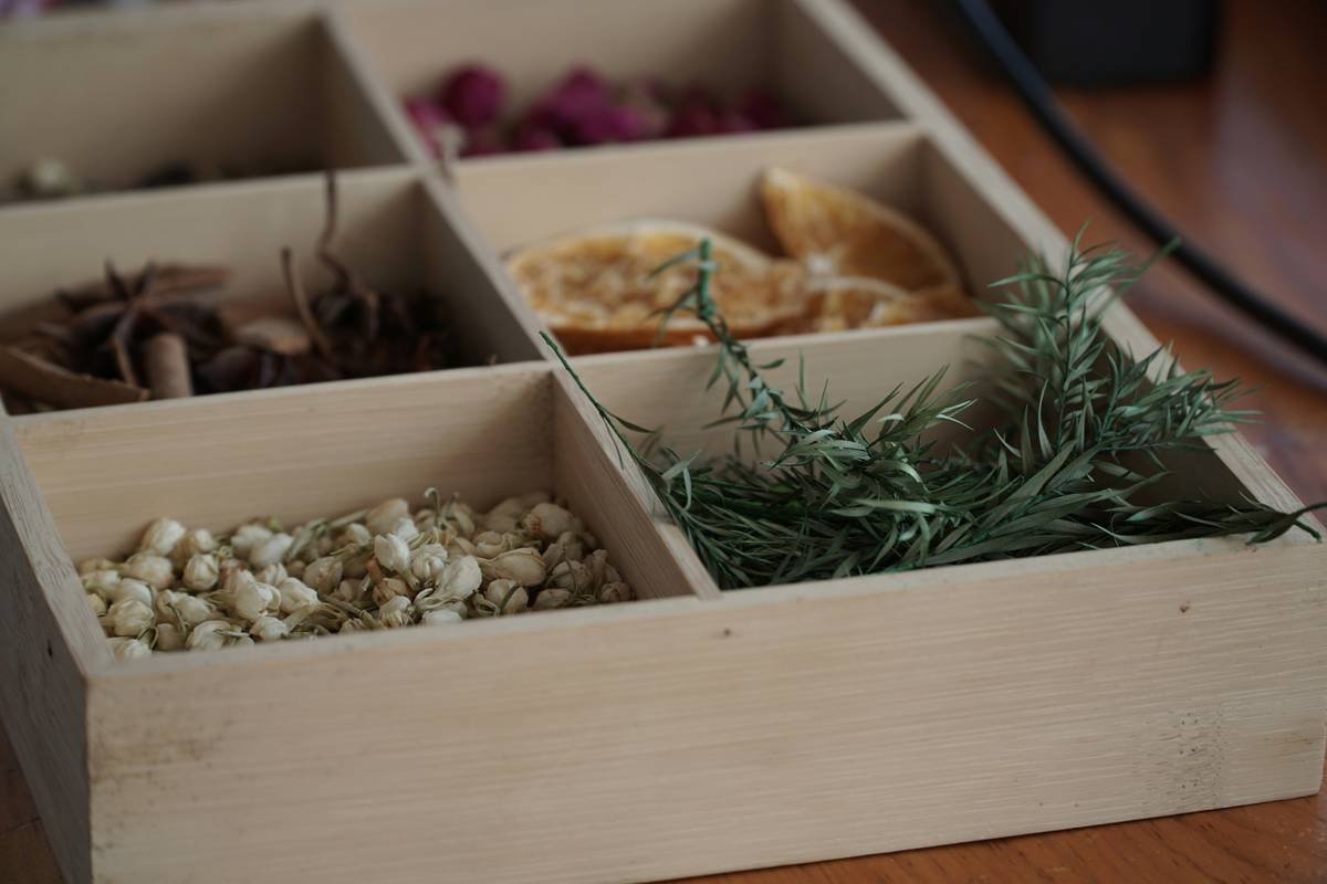 Herbs are processed to create a fragrance in preparation for making scented candles.