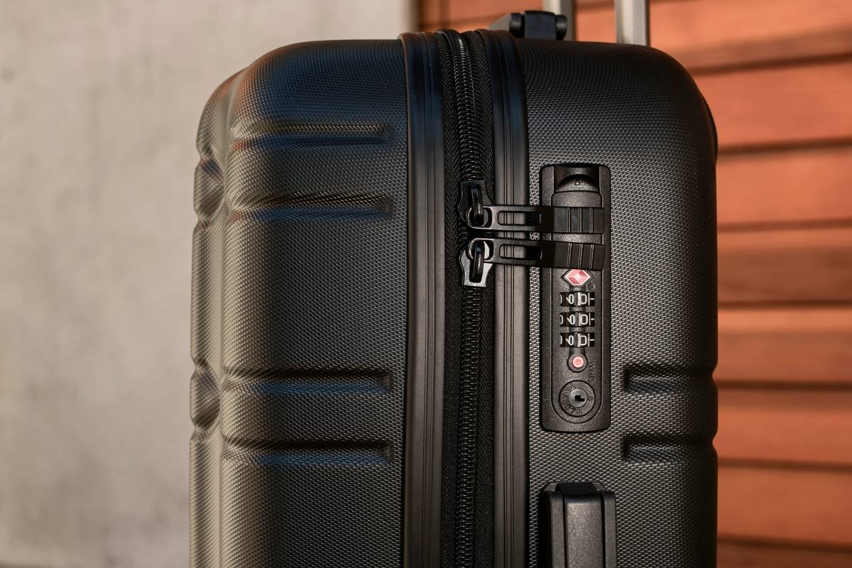 Infographic showing standard vs expanded luggage dimensions compared to airline carry-on limits, with red zones indicating non-compliant sizes