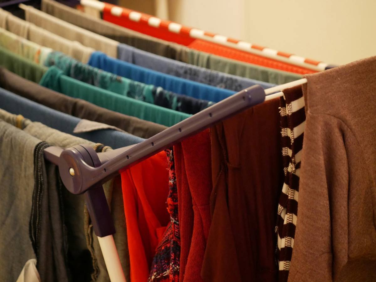 red and brown textile on white plastic clothes hanger