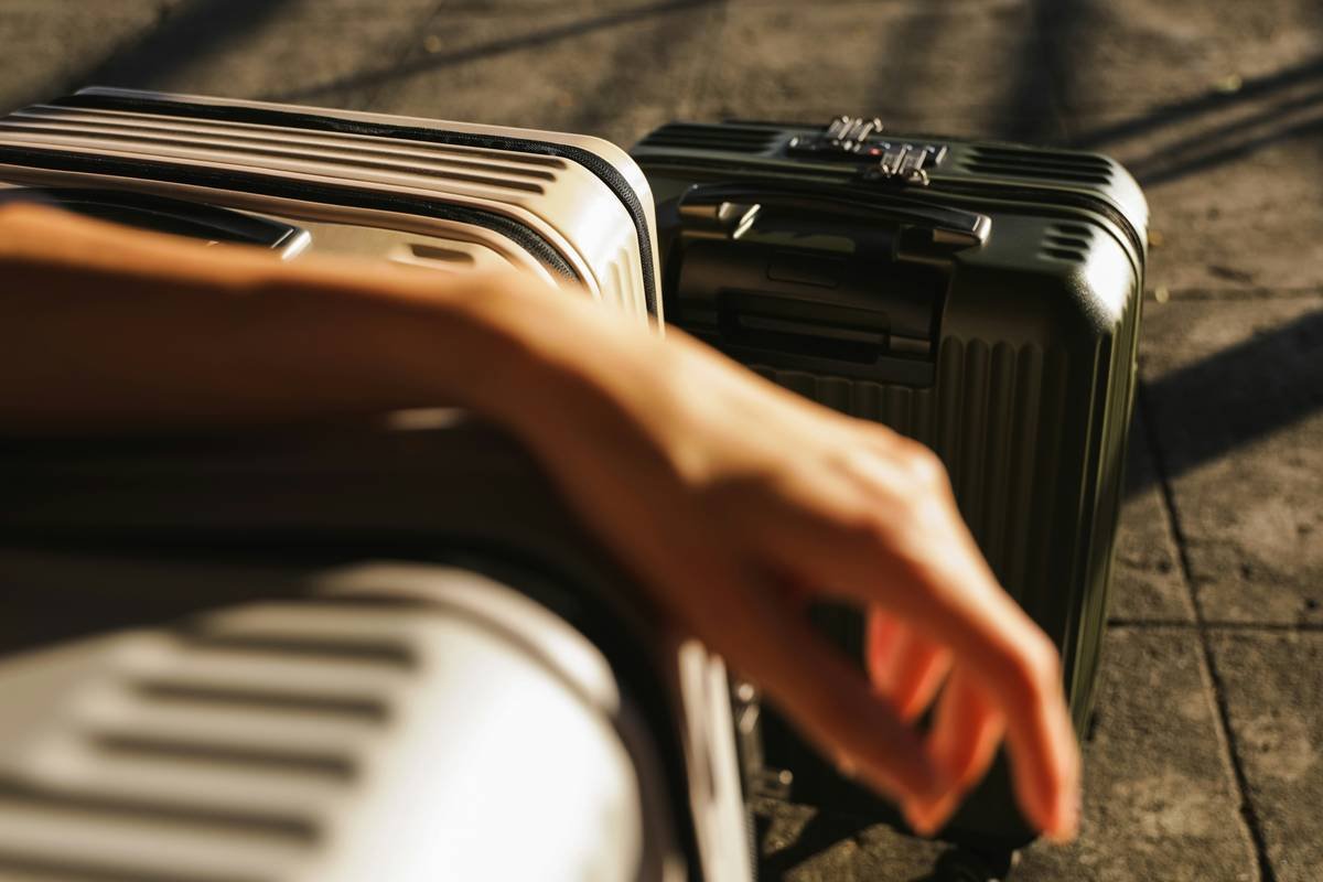 Infographic comparing standard vs expanded carry-on dimensions from top brands like Samsonite, Away, and Briggs & Riley, showing which stay within airline limits